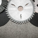 a set of abrasive tools and grinding discs on the background of sandpaper. essential tools for master builders.